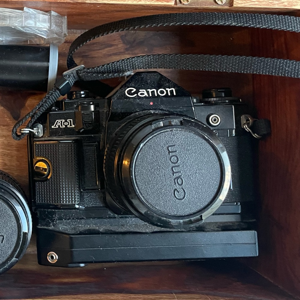 Canon a1 with motor drive and three lenses.